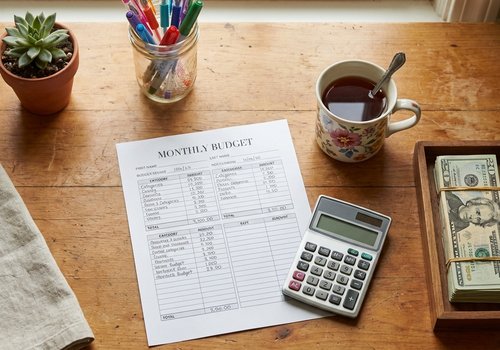Budget planning with notebook and calculator